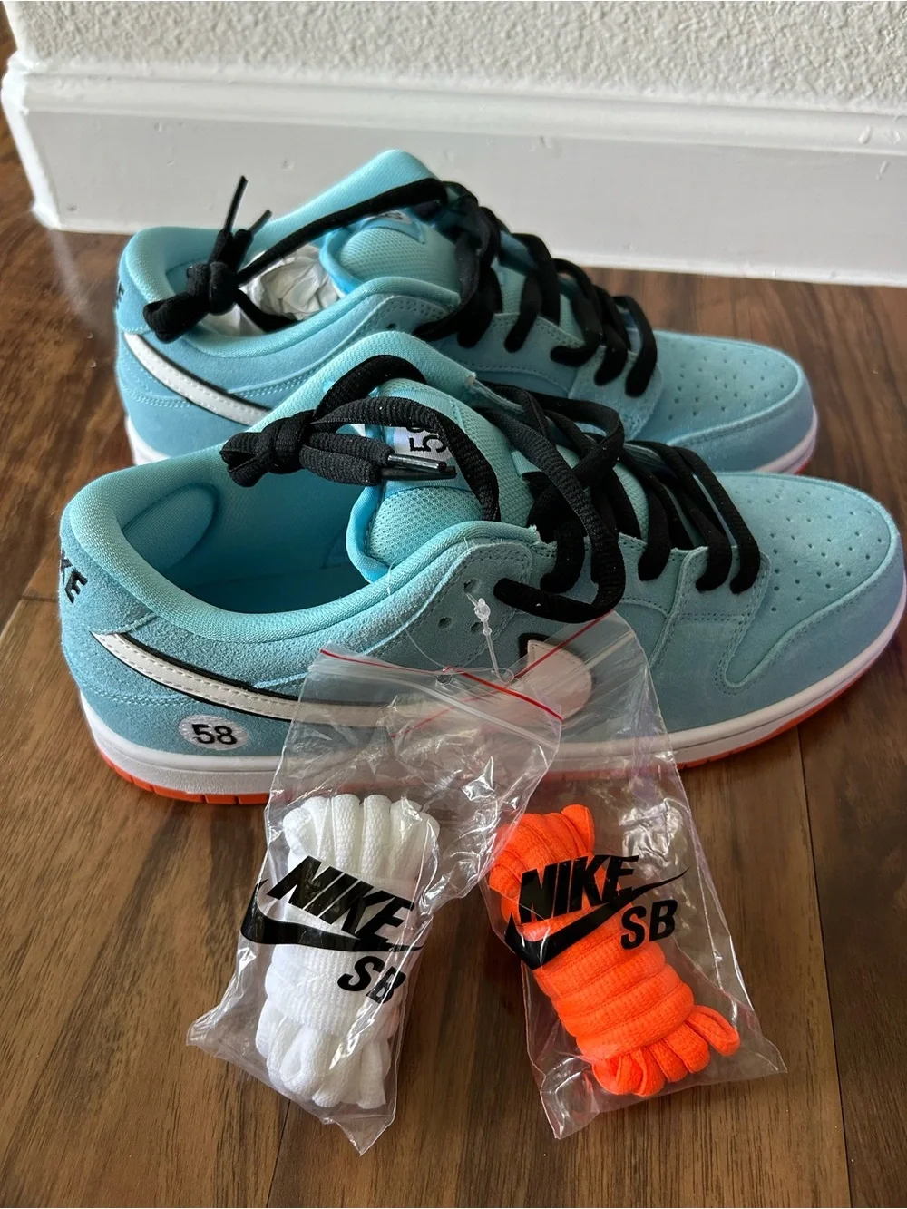 Nike Dunk Low Light Blue with White Swoosh and Orange Outsole